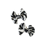 Two black and white striped hair bows on a white background