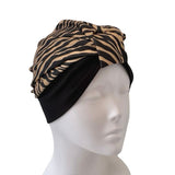 Zebra print headscarf on a mannequin head against a white background