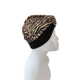 Turban with zebra pattern on a mannequin head against a white background