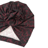 Plaid patterned headscarf with a knot on a white background