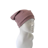 Pink beanie on a mannequin head against a white background