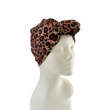 Leopard print headband on a mannequin head against a white background