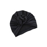 Black turban with a knot on a white background