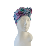 Colorful floral headscarf on a mannequin head against a white background