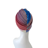 Colorful pleated headscarf on a mannequin head against a white background