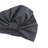 Dark gray headscarf with a large knot on a white background