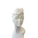 White headscarf on a mannequin head against a white background