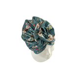 Floral patterned headscarf on a mannequin head against a white background