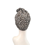 Leopard print headscarf on a mannequin head against a white background