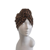 Leopard print headband on a mannequin head against a white background