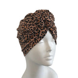 Leopard print headband on a mannequin head against a white background