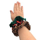 Hand wearing three patterned scrunchies on a white background ireland