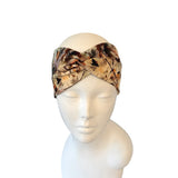 Camouflage-patterned headband on a mannequin head against a white background