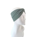 Green headband on a mannequin head against a white background