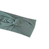 Green headband with a knot on a white background