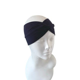 Navy blue headband on a mannequin head against a white background