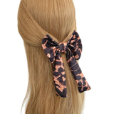 Hair tie with a decorative pattern tied around a person's hair on a white background
