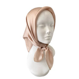 Mannequin head wearing a beige hijab on a white background