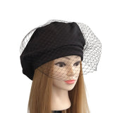 Black headscarf with a mesh veil on a mannequin head against a white background ireland