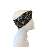 Floral patterned headband on a mannequin head against a white background