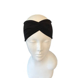 Black headband on a mannequin head against a white background