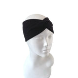 Black headband on a white mannequin head against a white background