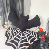 Halloween-themed decor with a black bat, skeleton, and spider web on a white background.