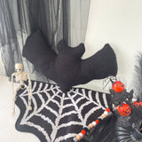 Halloween-themed decor with a black bat, skeleton, and spider web on a white background.
