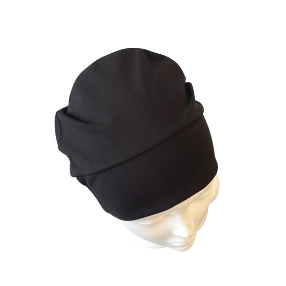Black beanie on a mannequin head against a white background