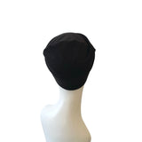 Black headscarf on a white mannequin head against a white background