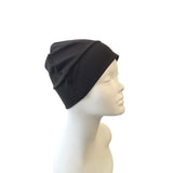 Black beanie on a mannequin head against a white background