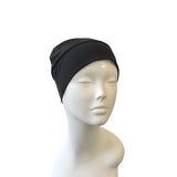 Black headscarf on a mannequin head against a white background