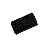 A black fabric headband with a large twisted knot detail at the center, displayed on a clean white background.