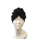 Black headscarf on a mannequin head against a white background