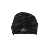 Black glittery turban on a white background