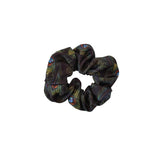 Black scrunchie with feather pattern on a white background