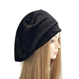 Black knit beanie on a mannequin head with long blonde hair against a white background