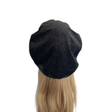 Black beanie on a mannequin head with blonde hair against a white background