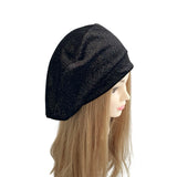 Black beanie on a mannequin head with long brown hair against a white background