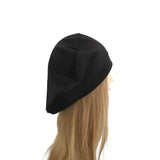 Black beanie on a mannequin head with blonde hair against a white background
