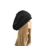 Black beanie on a mannequin head with long blonde hair against a white background