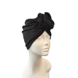 Black headscarf with a knot on a mannequin head against a white background