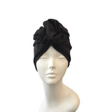 Black headscarf on a mannequin head against a white background