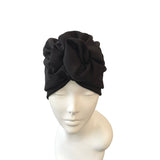 Black head wrap on a mannequin head against a white background