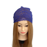 Blue lace headband on a mannequin head with long brown hair against a white background