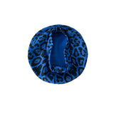 Blue leopard print headband on a white background
