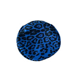 Blue and black leopard print round object on a white background