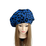 Blue leopard print beret on a mannequin head against a white background