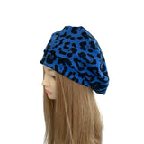 Blue leopard print headscarf on a mannequin head with long hair against a white background