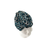 Leopard print turban on a mannequin head against a white background